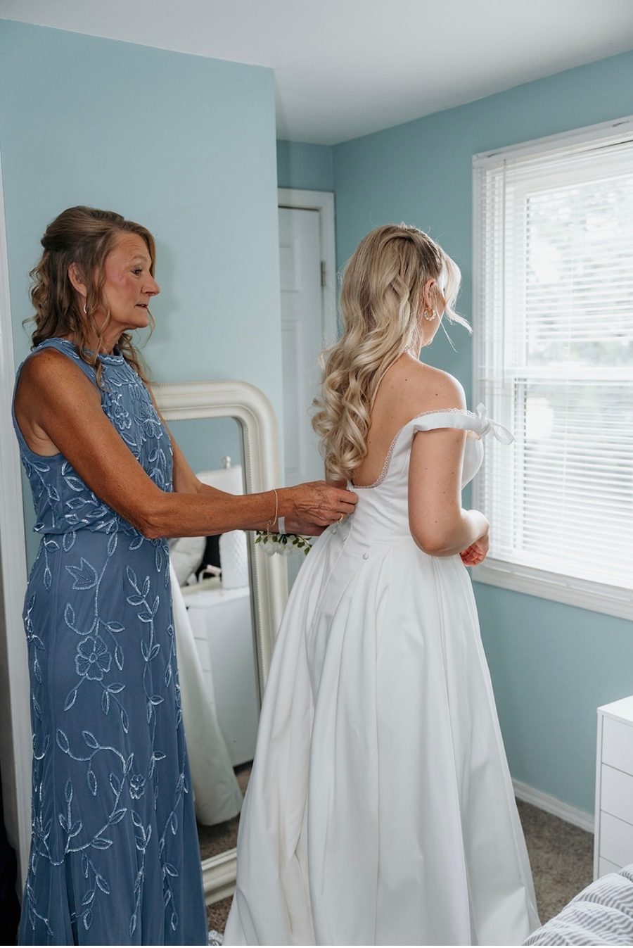 Bride with long blonde bridal waves getting ready