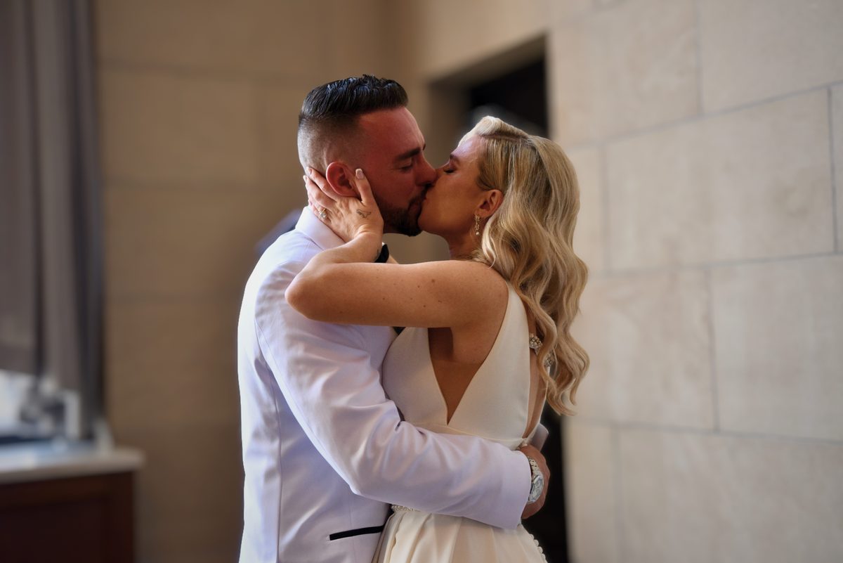 Bride and groom kissing after their wedding